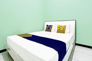 Postel nebo postele na pokoji v ubytování SPOT ON 92012 Homestay Grand Mahkota Permai Syariah