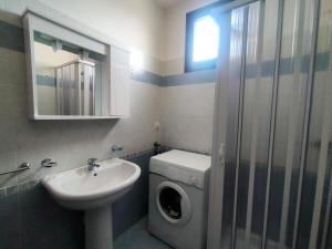 a bathroom with a washing machine and a sink at La Casa del Marinaio P1 in San Foca