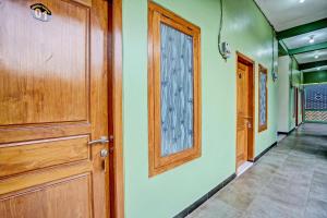 a room with a door and a hallway with a floor at OYO Life 92043 Kost Barokah Syariah Madiun in Madiun