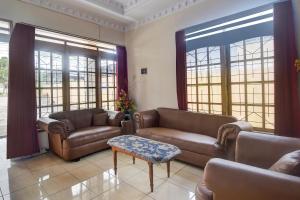 a living room with two couches and a table at Hotel O Borneo in Manado