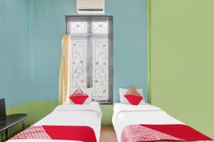 Ένα ή περισσότερα κρεβάτια σε δωμάτιο στο Hotel O Nirvana Homestay Syariah