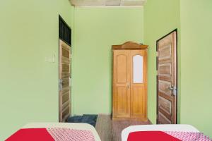 Ένα ή περισσότερα κρεβάτια σε δωμάτιο στο Hotel O Nirvana Homestay Syariah +17 φωτογραφίες