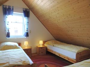 a bedroom with two beds and a window at Südblick 2Whg 6 in Werdum