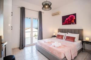 En eller flere senge i et værelse på Villa Margarita