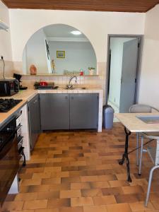 a kitchen with a sink and a table at Quadrale in Sotta