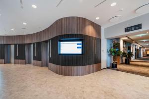 eine Lobby mit einem Flachbild-TV an der Wand in der Unterkunft Hotel Berlin, Berlin, a member of Radisson Individuals in Berlin