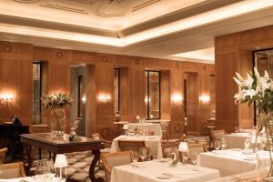a restaurant with white tables and chairs and flowers at Anassa in Polis Chrysochous