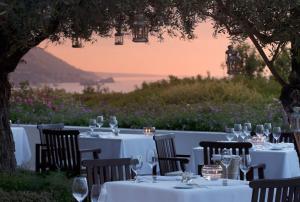 a table with white table cloths and wine glasses at Anassa in Polis Chrysochous