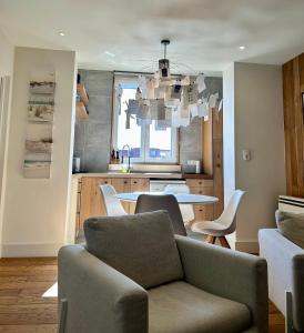 a living room with a couch and a table at Lou Le Lavandou in De Panne +12 photos