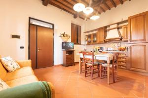 a kitchen with a table and chairs in a room at Cognaia Country by Holiday World in Arezzo +18 photos