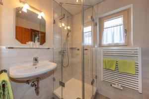 a bathroom with a sink and a shower at Ferienwohnungen Hanslbauer in Krün +20 photos