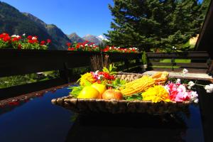 a basket of fruit and vegetables on a table at Villa Grossglockner Heiligenblut in Heiligenblut