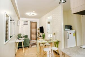 a kitchen and living room with a table and a refrigerator at AR09 HBRentals 1BR Smart Unit in Davao City