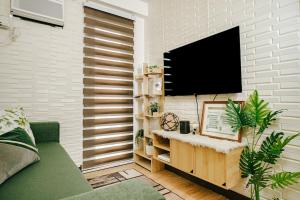a living room with a flat screen tv on a wall at AR09 HBRentals 1BR Smart Unit in Davao City