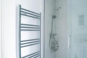 a shower in a bathroom with a glass door at New Snug DoubleEnsuite in Central Forest Row in Forest Row
