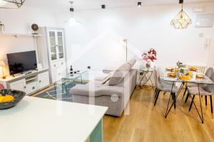a living room with a couch and a table at A Paicega - Oviedo Centro in Oviedo