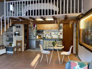 a kitchen and dining room with a table and chairs at Gure Txokoa in Cerain