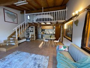 a living room with a couch and a table and stairs at Gure Txokoa in Cerain +22 photos
