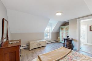 an empty living room with a staircase and a room at Lobster Cove Retreat in Prospect Harbor