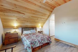 a bedroom with a bed and a wooden ceiling at Lobster Cove Retreat in Prospect Harbor