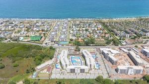an aerial view of a large city next to the ocean at Malia Beach Experience - Muro Alto - Vista piscina central - Flat 205C in Ipojuca