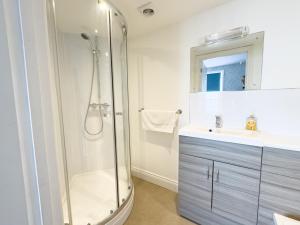 a bathroom with a shower and a sink at Seasons in Weymouth +41 photos