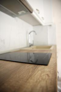 a kitchen with a sink and a wooden counter top at 4Keys Apartments Nikiti in Nikiti