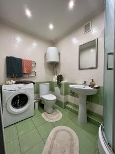 un bagno con lavatrice e lavandino di Центр Медова Квартира подобово a Ternopilʼ