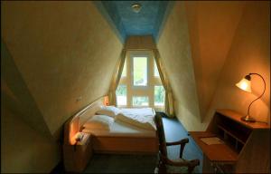 a small bedroom with a bed and a window at Hotel Bischof in Schmallenberg