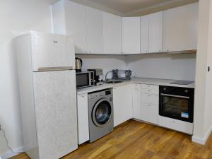 a kitchen with a refrigerator and a washing machine at Sofia hotel apartments in Sofia