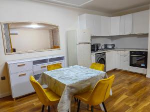 a kitchen with a table and chairs in a room at Sofia hotel apartments in Sofia +54 photos