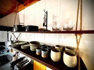a kitchen with pots and glasses on a shelf at Morning Star La Lastra - St Ignatius House in La Lastra