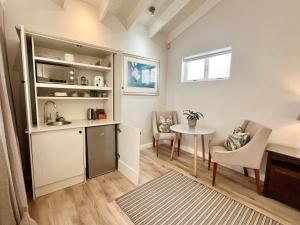a small kitchen and dining room with a table at Oakvale Lodge in Cape Town