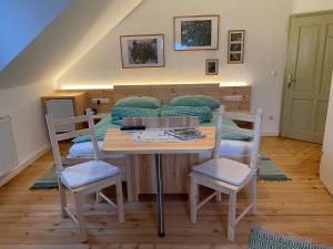a table and chairs in a room with a bed at Ferienhof Zamsegg in Vordertambergau