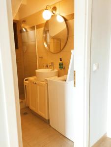 a bathroom with a sink and a mirror at Artistic elegant home in Afitos