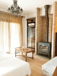 a living room with two beds and a fireplace at Artistic elegant home in Afitos