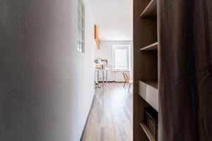 a hallway with wooden floors and a room with a table at Le Cosy in Tournon-sur-Rhône +10 photos