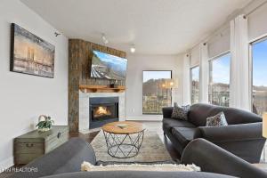 a living room with a couch and a fireplace at River Place Condos #610 3BD in Pigeon Forge