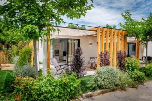 a home with a garden with a wooden fence at La Mimosa Camping in Fano