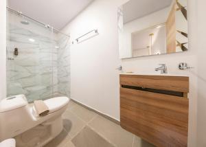 a bathroom with a shower and a toilet and a sink at Hotel Blu Sai in San Andrés