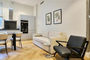 a living room with a couch and chairs and a table at Apartments Garitsa 1 in Ágios Rókkos