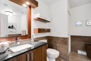 a bathroom with a sink and a toilet at Condo Luxueux au pied du Mont in Saint-Sauveur-des-Monts +22 photos