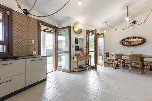 a kitchen with a table and a dining room at GuestHost - Domus Ritae in Domus de Maria