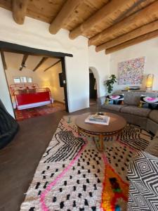 a living room with a couch and a table at Spacious Stylish Niji Suite in Santa Fe