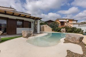 a swimming pool in the backyard of a house at GuestHost - Domus Ritae in Domus de Maria