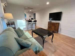 a living room with a couch and a coffee table at East Side Blue Bonnet Cottage in Austin
