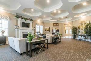 a living room with white furniture and a fireplace at The Villas Antilia in Durham