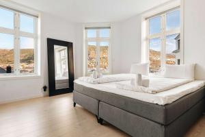 a large bedroom with two beds and large windows at DINBNB Apartments l Luxury Penthouse l Roof Terrace l Central Bergen in Bergen