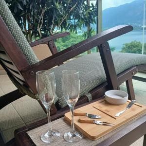 two wine glasses sitting on a tray on a table at Apart-Hotel Vista Frontal em Ipanema in Rio de Janeiro