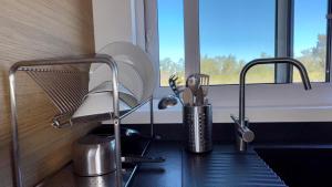 a kitchen counter with a sink and a window at LAZY HIKERS by Nature Bliss in São Luis